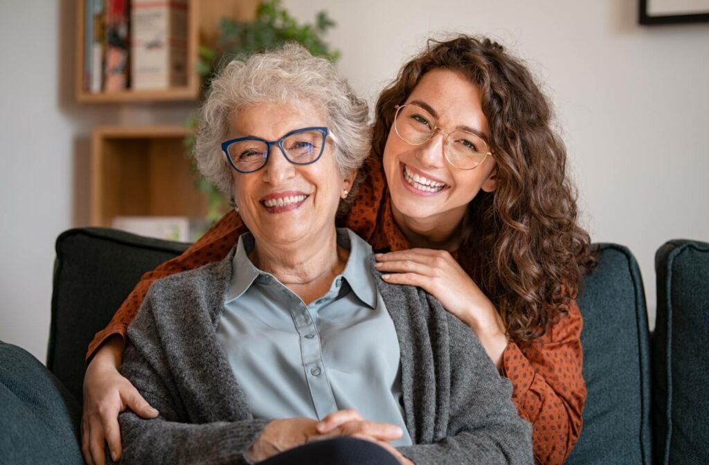Two people smiling and wearing modern eyeglass frames.